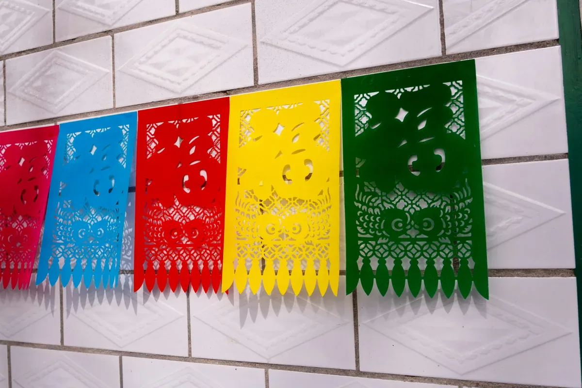 Colorful papel picado banner hung for a celebration