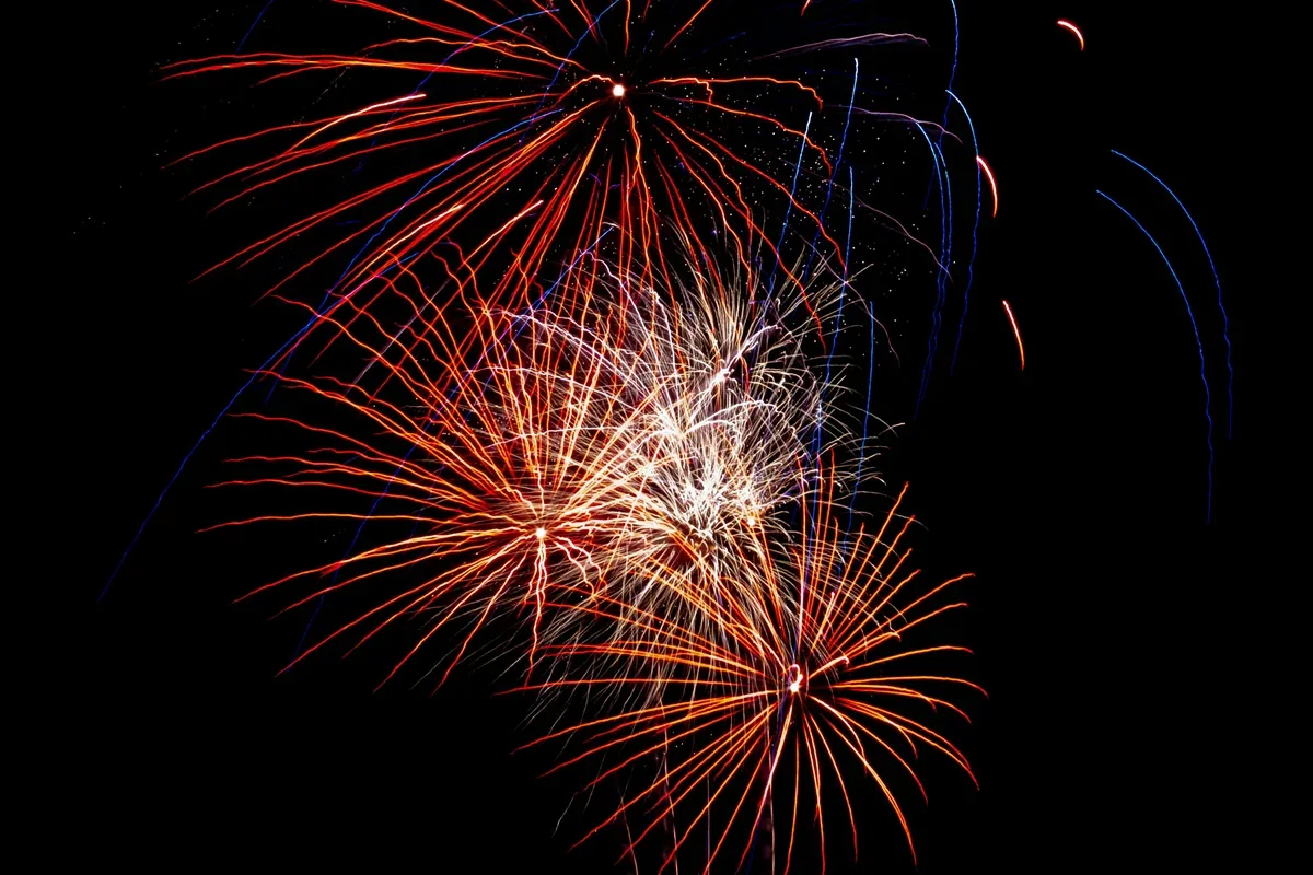 Layered paper bursts and stars arranged for a photo backdrop
