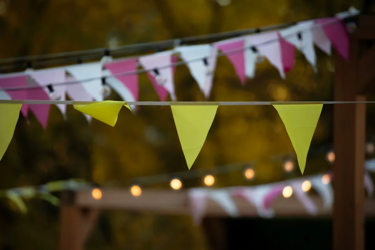 Paper bunting banner hanging as backyard party decor